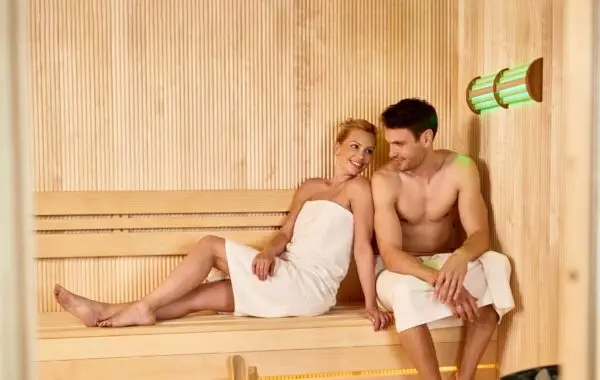 Smiling Couple Communicating While Sitting Sauna Health Spa.webp